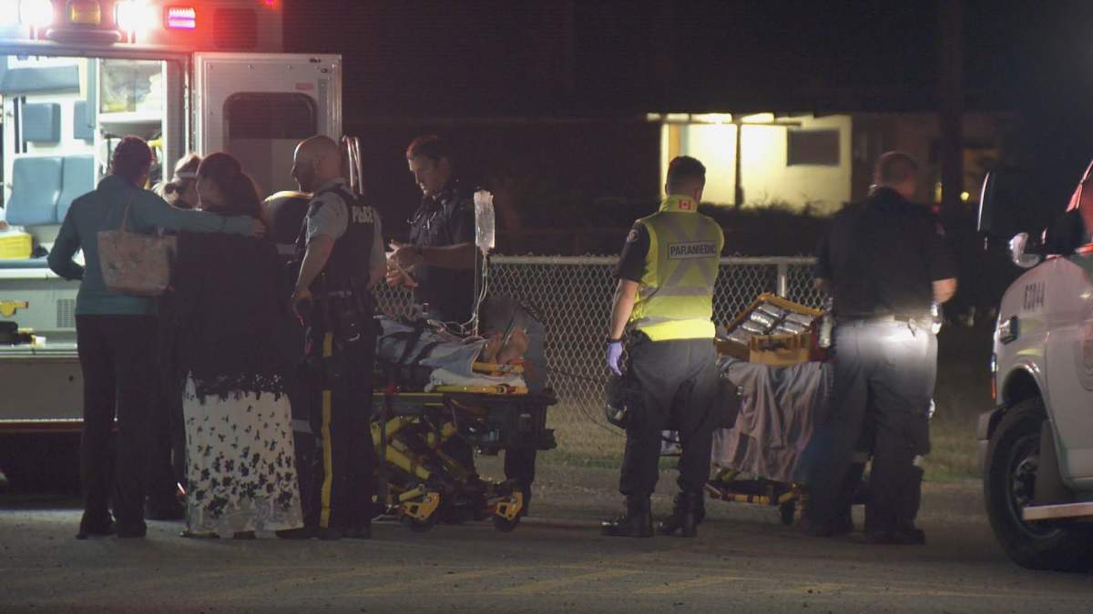 Paramedics attend to a man who suffered critical injuries on Thursday night. 