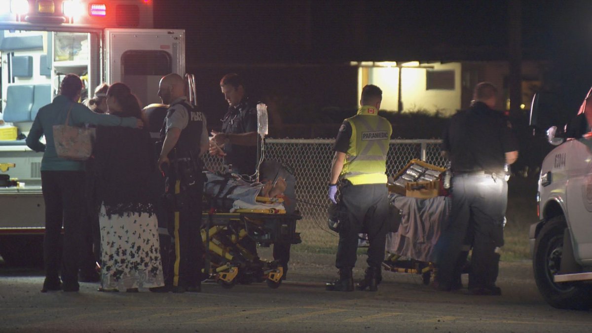 Paramedics attend to a man who suffered critical injuries on Thursday night. 