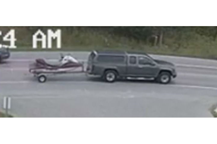 The items that were allegedly stolen were towed by what appears to be a grey or brown Chevrolet Silverado with a matching cap and black roof rack.