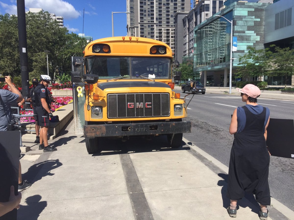 An anti-hate protest at Hamilton city hall saw a school bus with anti-immigration slogans pull up onto the sidewalk and park in front of protesters on Saturday.