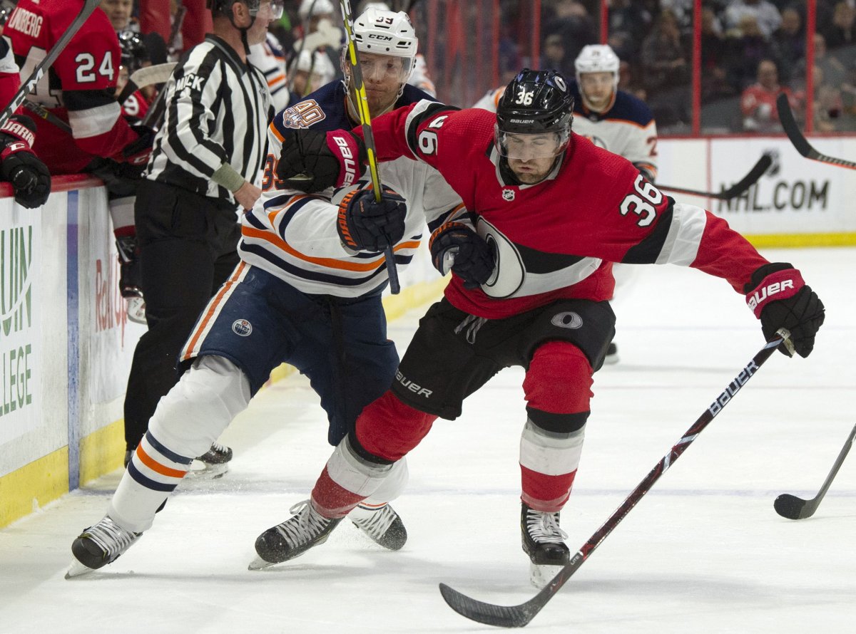 Ottawa Senators centre Colin White (36) collides with Edmonton Oilers right wing Alex Chiasson along the boards during second period NHL action in Ottawa, Thursday, Feb. 28, 2019.