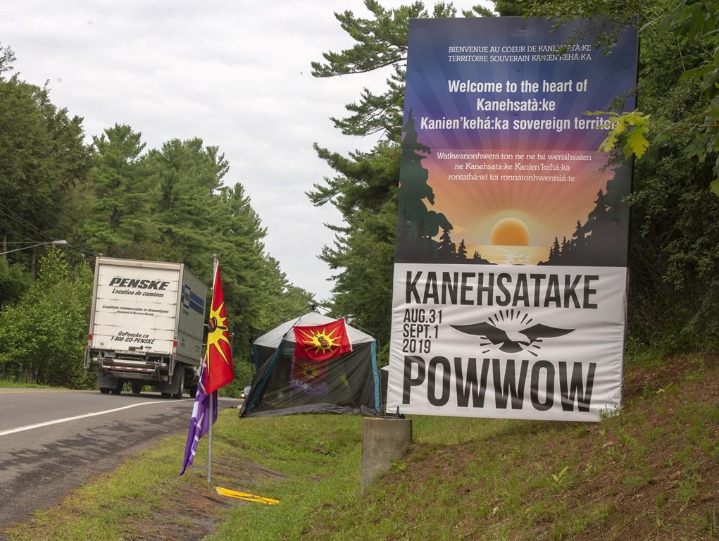 Mohawk flags are placed at the border of the Kanasatake Mohawk territory Friday, July 19, 2019 in Oka, Que.