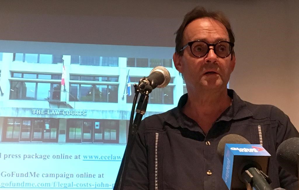 John Perkins, a member of Sustainable Northern Nova Scotia, announces he is launching a lawsuit in connection with his arrest at a public meeting in May to discuss gold mining near Sherbrooke, N.S., August 13, 2019. THE CANADIAN PRESS/Keith Doucette