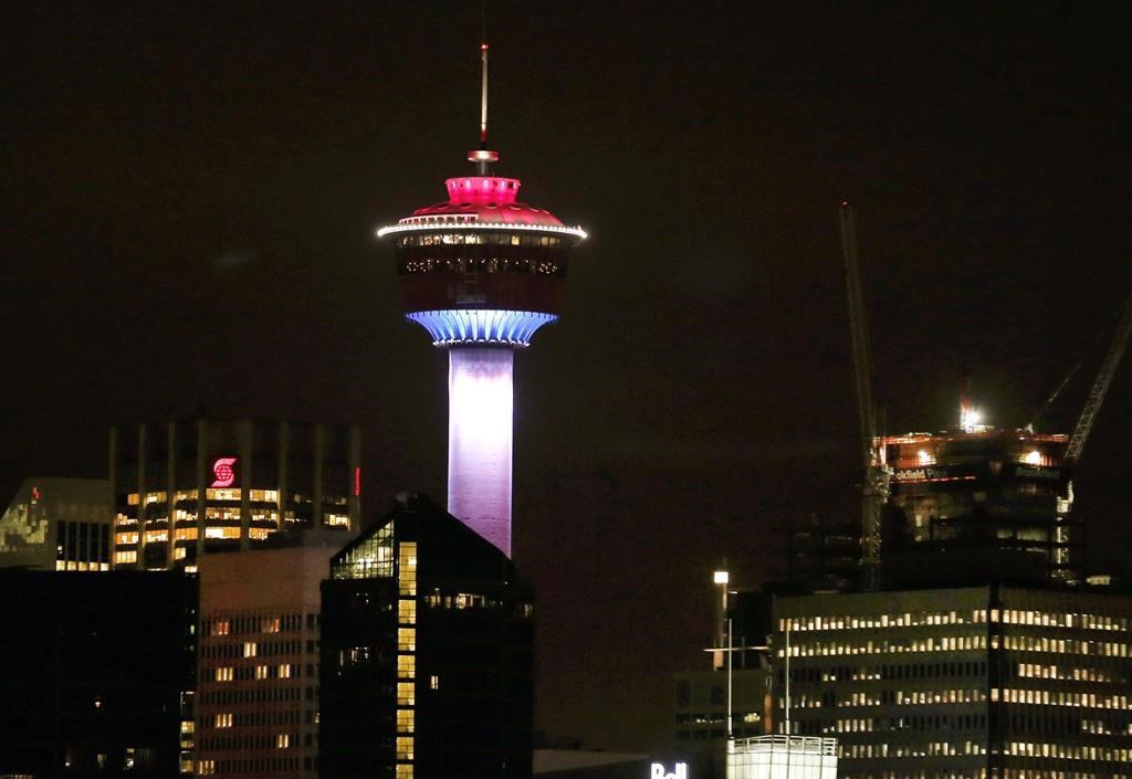 The Calgary Tower is lit up with the colors of the French flag to show support and sympathy regarding the Paris attacks in Calgary, Alta. on Friday, Nov. 13, 2015. One of Calgary's most recognizable landmarks remains closed seven weeks after an elevator with eight people on board plunged several floors.