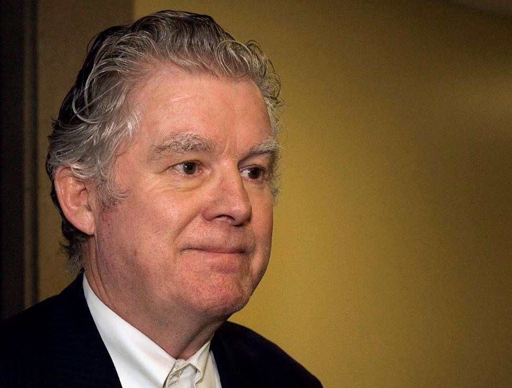 Ernest Fenwick MacIntosh heads from Nova Scotia Court of Appeal in Halifax on Thursday, Oct. 7, 2010. A Nova Scotia man who served time in a Nepalese prison for sexually abusing a youth has been charged in a Quebec court with failing to report his location to Canadian authorities after he returned to the country.