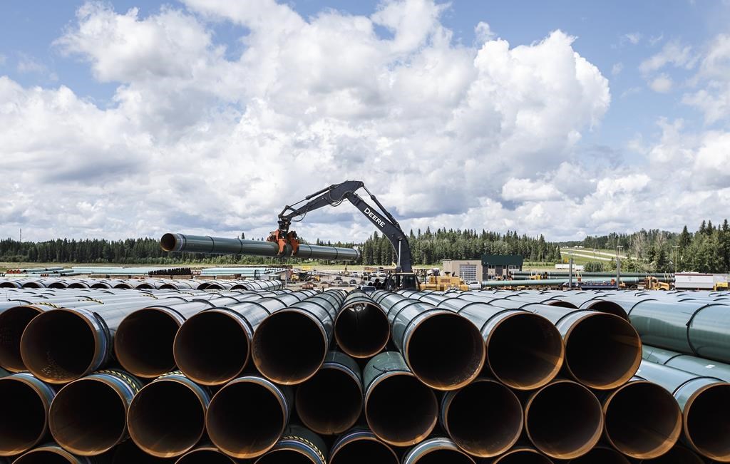 Pipe for the Trans Mountain pipeline is unloaded in Edson, Alta. on Tuesday June 18, 2019.
