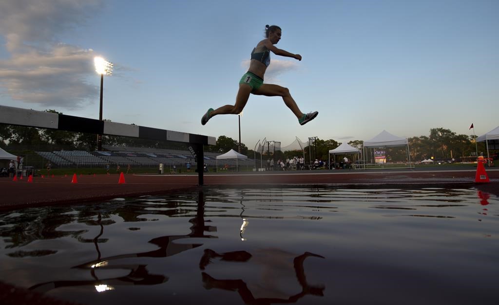Women's 3000 metre steeplechase gold medallist Genevieve Lalonde leaps over a hurdle at the Canadian Championships in Montreal on Thursday, July 25, 2019. THE CANADIAN PRESS/Paul Chiasson.