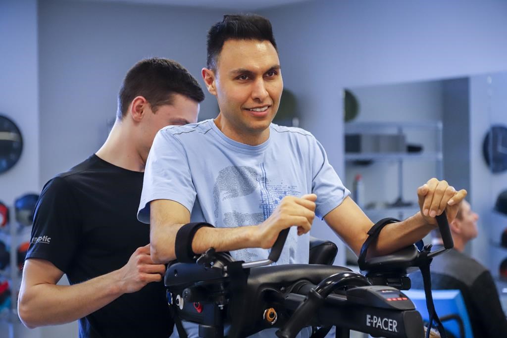 Dr. Richi Gill, in grey shirt, a Calgary doctor, takes part in physiotherapy in Calgary, Wednesday, Feb. 13, 2019.