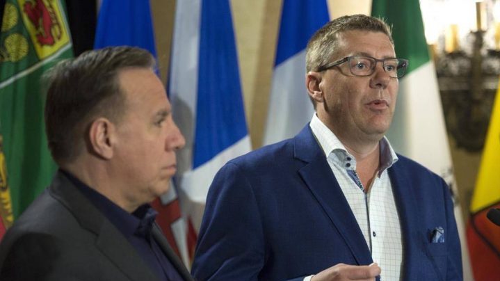 Saskatchewan Premier Scott Moe, right and Quebec Premier Francois Legault address the media during a meeting of Canada's Premiers in Saskatoon on Wednesday, July 10, 2019. The Saskatchewan government says the federal carbon tax is killing jobs, but experts and even the province's trade minister say it's not that easy to calculate. THE CANADIAN PRESS/Jonathan Hayward.