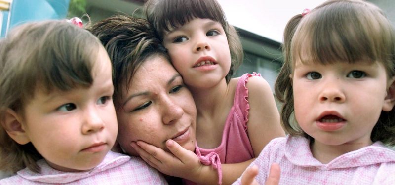 Bobbi-Jo Eckhard poses with her three children, Chelsey, Kay-Lee and Kassidy, all three years old, in Calgary in this July 31, 2001, file photo. Bobbi-Jo lost her husband, Ryan, in the Aug. 9, 1999, Hub Oil explosion.
