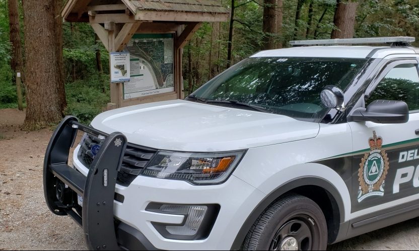 Delta police outside the trailhead at Watershed Park, where a man was allegedly confronted over bags of meat during a scare over meat being dropped near the trail this summer.