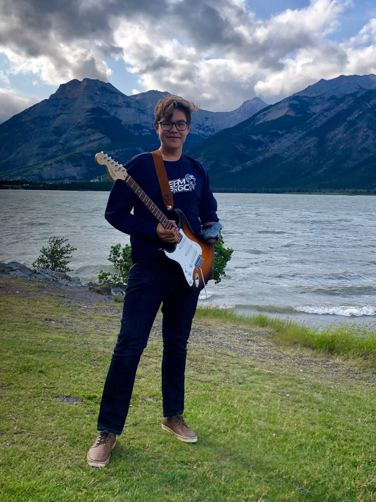 A recent photo of Dillon Gazandlare with his guitar near Banff, Alta.