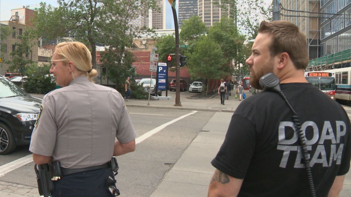 A DOAP Team member walks with a Calgary Bylaw officer in the city's downtown core. 