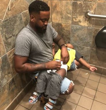 Donte Palmer posted a photo of him changing his child on his lap and it went viral.