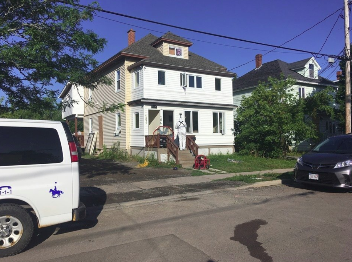 Investigators in HAZMAT suits enter a home in Moncton as part of an ongoing drug investigation on Wednesday, Aug. 28, 2019. 