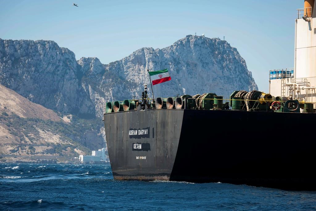 Renamed Adrian Aryra 1 super tanker hosting an Iranian flag sails in the waters in the British territory of Gibraltar, Sunday, Aug. 18, 2019. Authorities in Gibraltar on Sunday rejected the United States' latest request not to release a seized Iranian supertanker, clearing the way for the vessel to set sail after being detained last month for allegedly attempting to breach European Union sanctions on Syria.