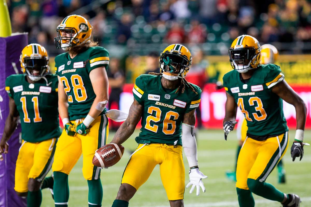 Edmonton Eskimos' Larry Dean (11), Jordan Hoover (28), Josh Johnson (26) and Vontae Diggs (43) celebrate their victory over the Ottawa Redblacks during first half CFL action in Edmonton on Friday, August 9, 2019. 