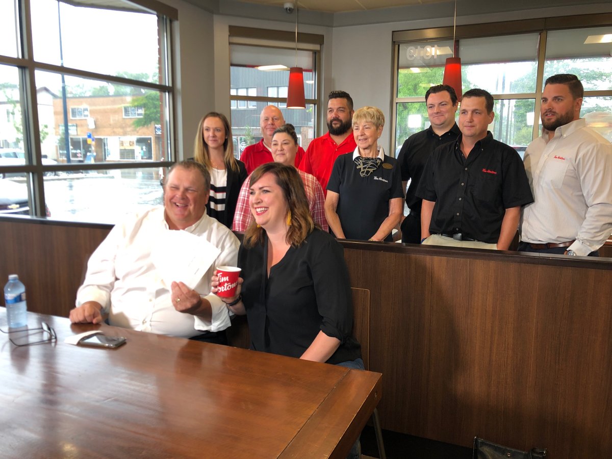 Tim Hortons store owner Chris Sparling with Kate Graham, a volunteer with the Old East Village Community Association (left to right) and London Tim Hortons franchise owners donating money to the OEVCA fund to support those impacted by the London gas explosion.