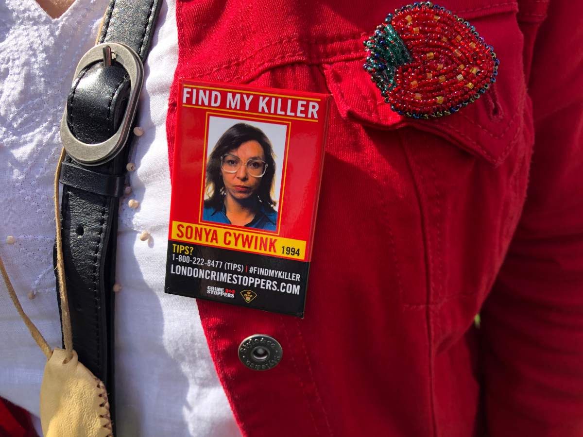 During a solidarity walk in 2019, Meggie Cywink wears a pin that pleads for help in the search for her sister Sonya’s killer.