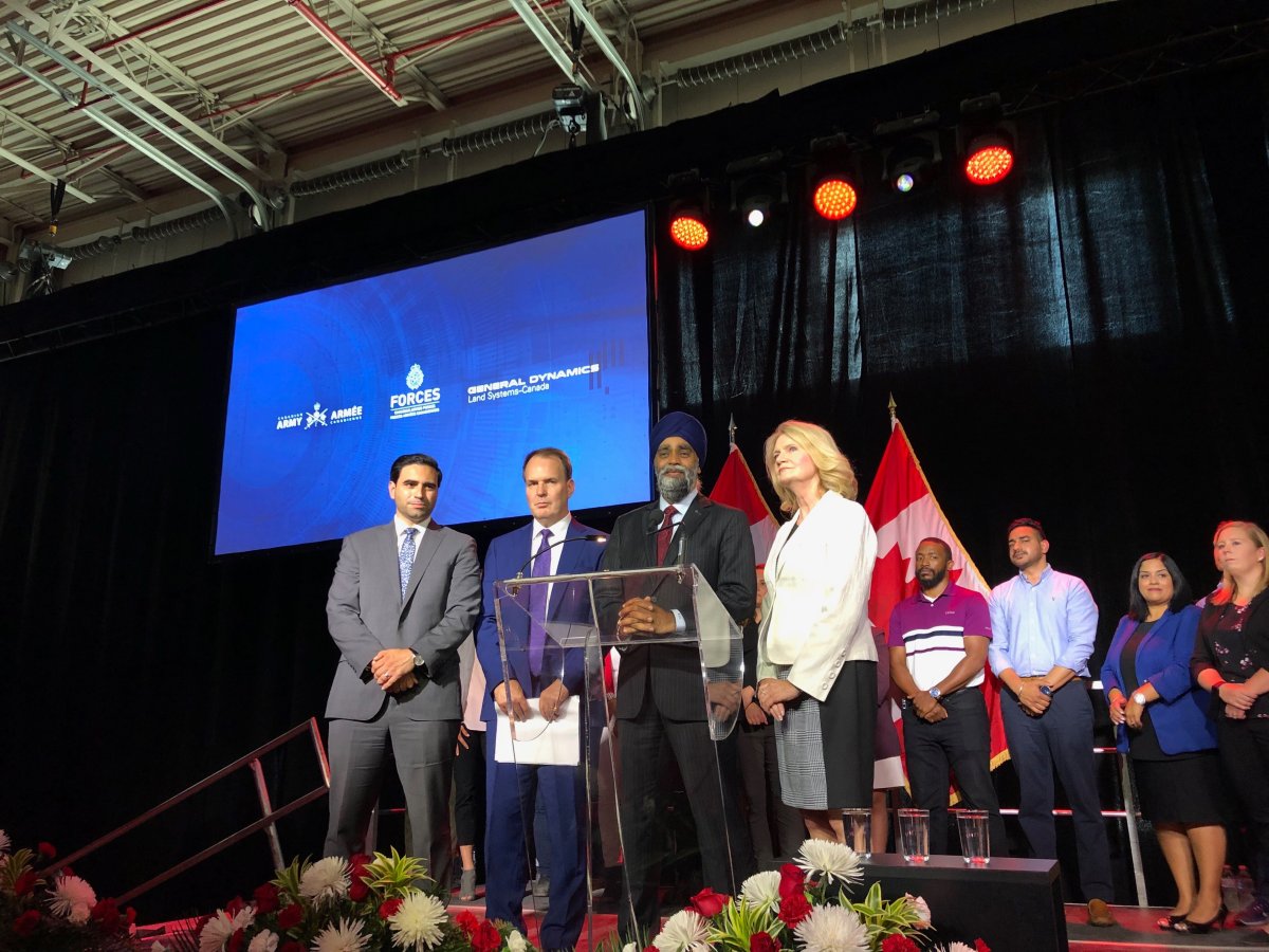 Defence Minister Harjit Sajjan, second from right, is joined by Liberal MPs Peter Fragiskatos, left, and Kate Young for Friday's announcement in London, Ont.