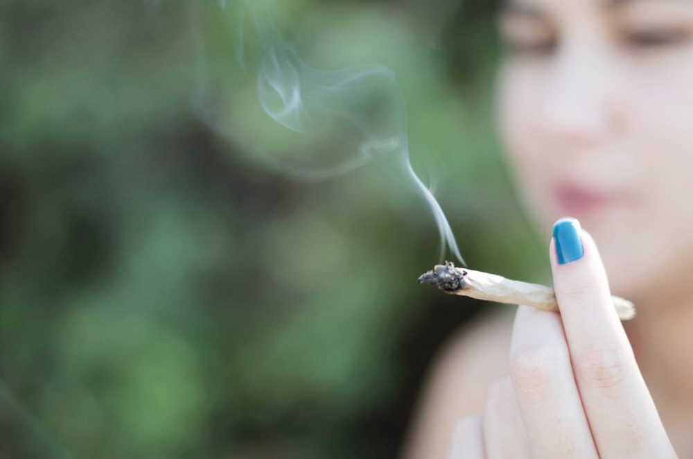 A woman smokes cannabis in this file image. 