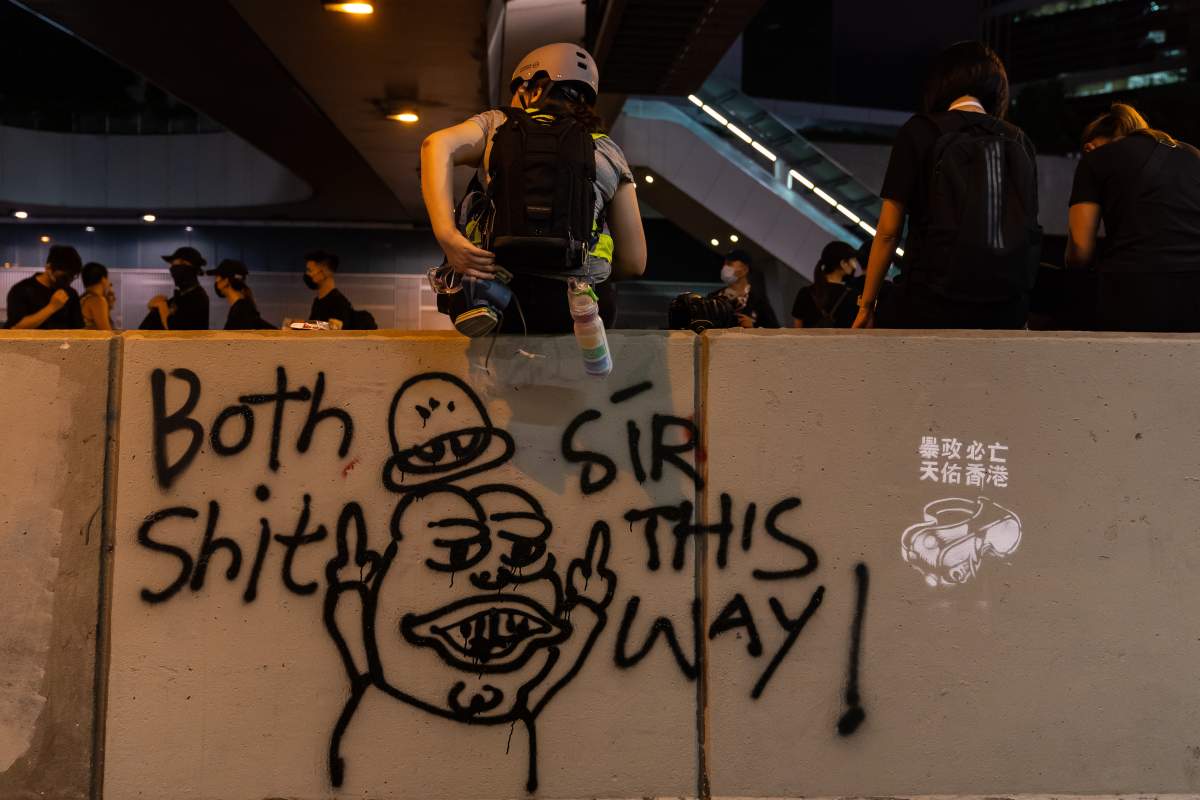 Protesters gather next to graffiti of “Pepe the Frog”, outside the Central Government complex after a march during a demonstration on August 18, 2019 in Hong Kong, China.  (Photo by Billy H.C. Kwok/Getty Images)
