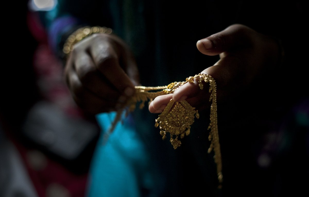 Gold wedding jewelry is laid out for a wedding on August 20, 2015 in Manikganj, Bangladesh.  