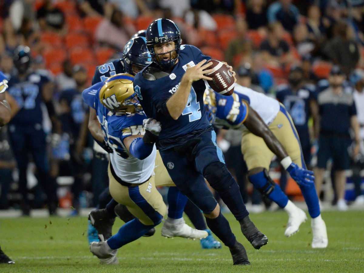 Toronto Argonauts quarterback McLeod Bethel-Thompson (4) runs for the first down against the Winnipeg Blue Bombers during second half CFL football action in Toronto on Thursday.