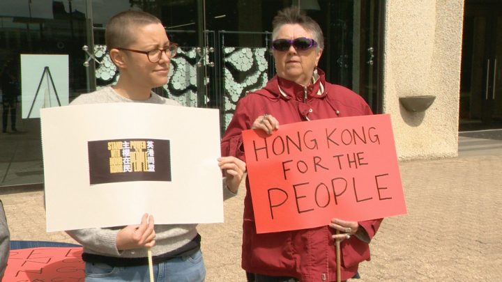 A group gathered outside Regina City Hall Saturday to voice solidarity with those protesting in Hong Kong. 