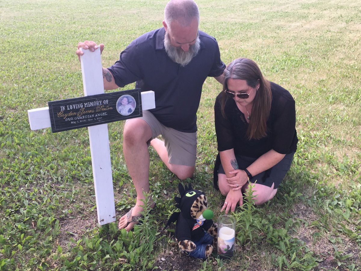 The Bottle family at the site of their son Cayden's grave.