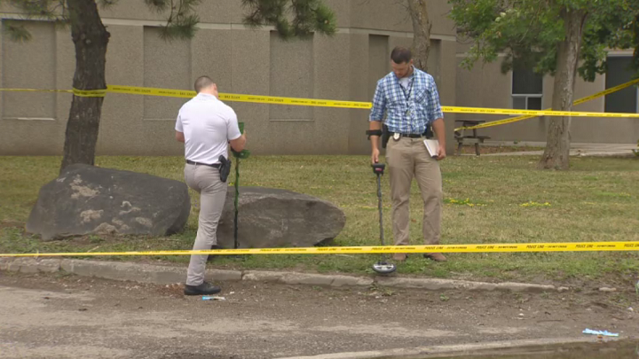 Detectives at the scene of the shooting Sunday morning canvassing the area for evidence.
