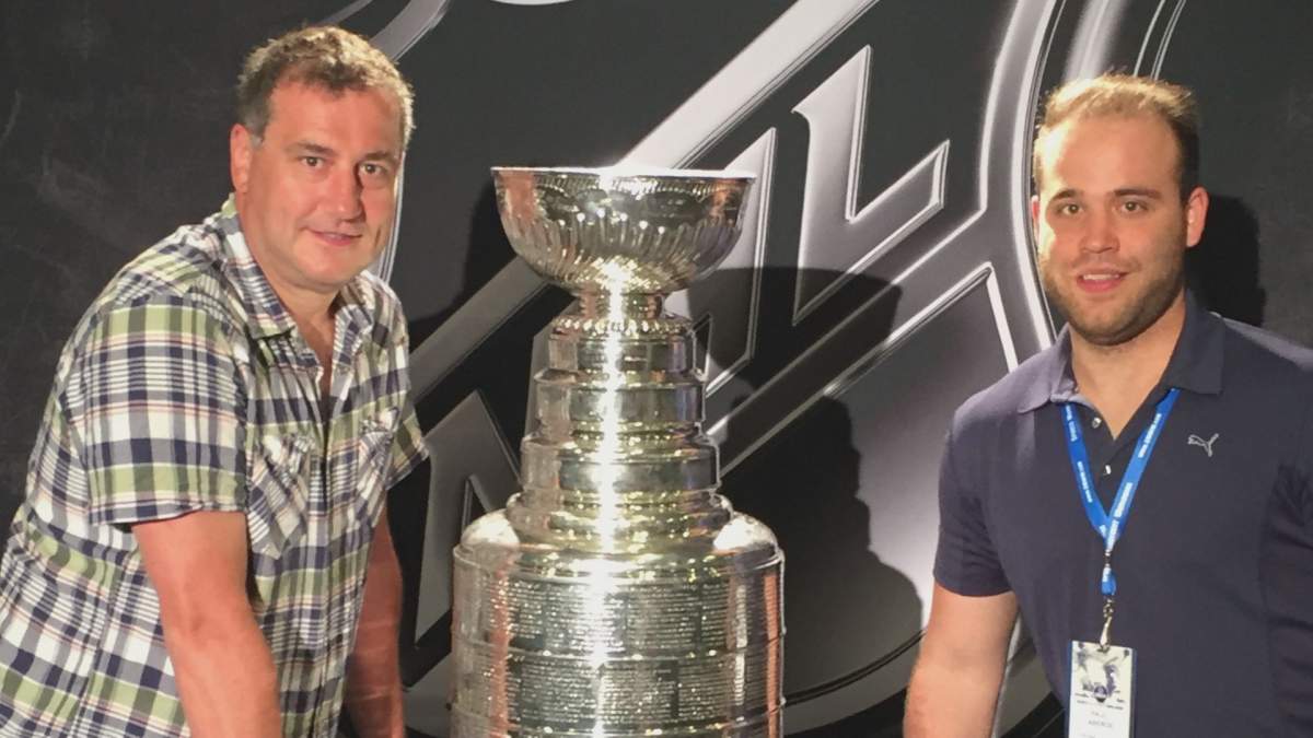 Marcel Laberge (left) and Paul Laberge (right) pose for a picture with the Stanley Cup.