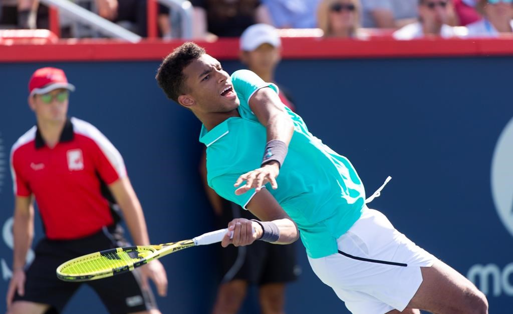 Felix Auger-Aliassime of Canada loses his balance as he returns to Karen Khachanov of Russia during round of sixteen play at the Rogers Cup tennis tournament Thursday August 8, 2019 in Montreal.