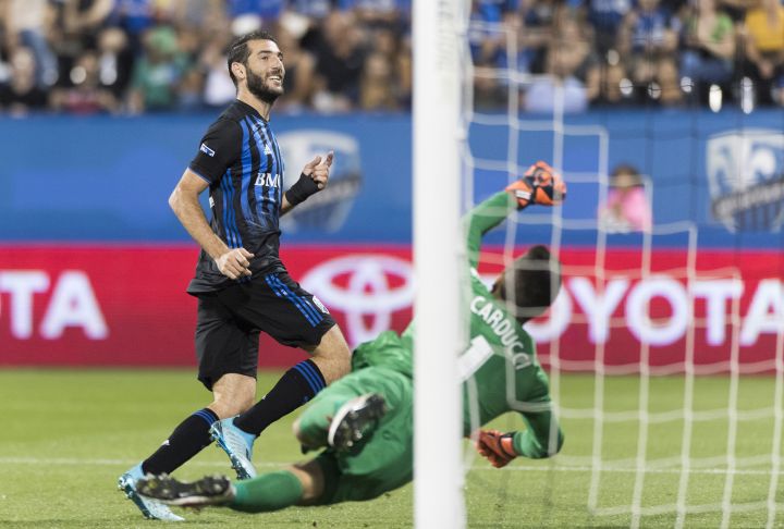 Montreal Impact's Ignacio Piatti scores against Cavalry Fc's goalkeeper Marco Carducci during second half semifinal Canadian Championship soccer action in Montreal, Wednesday, August 7, 2019. 