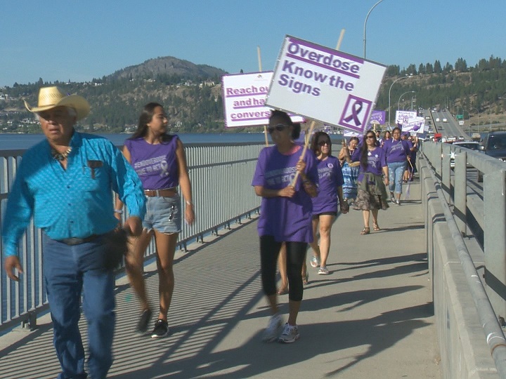 Members of the Purple Ribbon Campaign Caravan walk across the W.R. Bennett bridge on Wednesday morning.