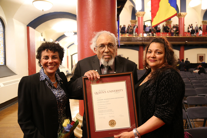 Dr. Maria Bartholomew, left to right, great niece of Ethelbert, Daniel Bartholomew, son of Ethelbert, and Rosalyn Bartholomew, grand daughter of Ethelbert, pose for a photo with Ethelbert Bartholomew's graduating certificate in Kingston.