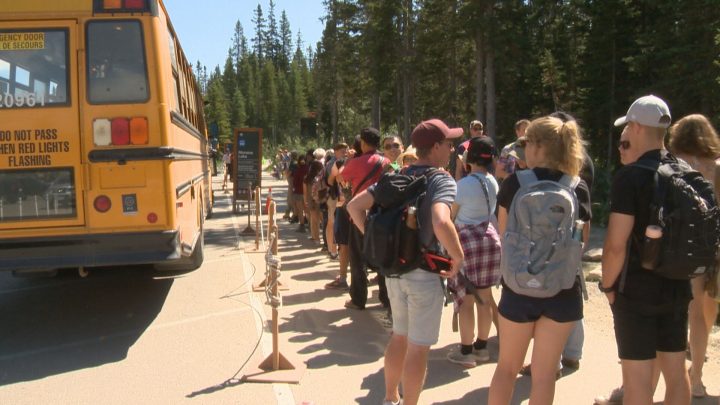 People had to wait in long lines for shuttles at Lake Louise over August long weekend in 2019.