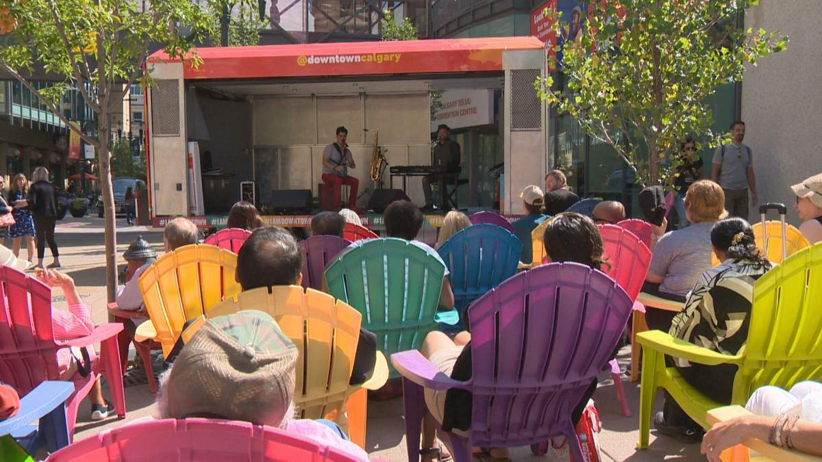People enjoy a live performance on Calgary’s Stephen Avenue on Thursday, Aug. 1.