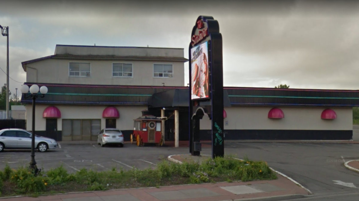 Police say a motorcycle rider fired multiple shots while travelling at high speed through a strip club parking lot in Niagara Falls on Friday morning.