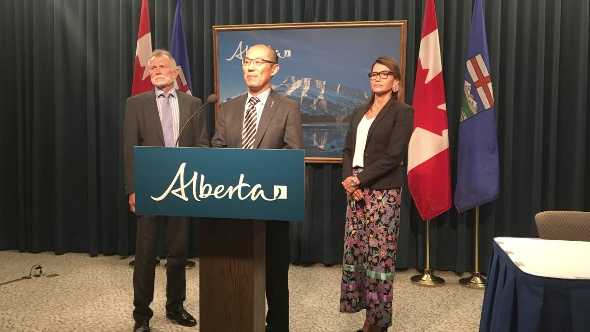 Associate Minister Jason Luan stands with the chair and vice-chair of the Supervised Consumption Services Review Committee. Monday, Aug. 19, 2019.