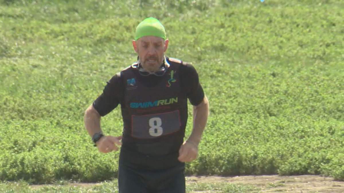 An athlete running towards the finish line at Edmonton’s inaugural SwimRun event on Sunday, August 4, 2019.