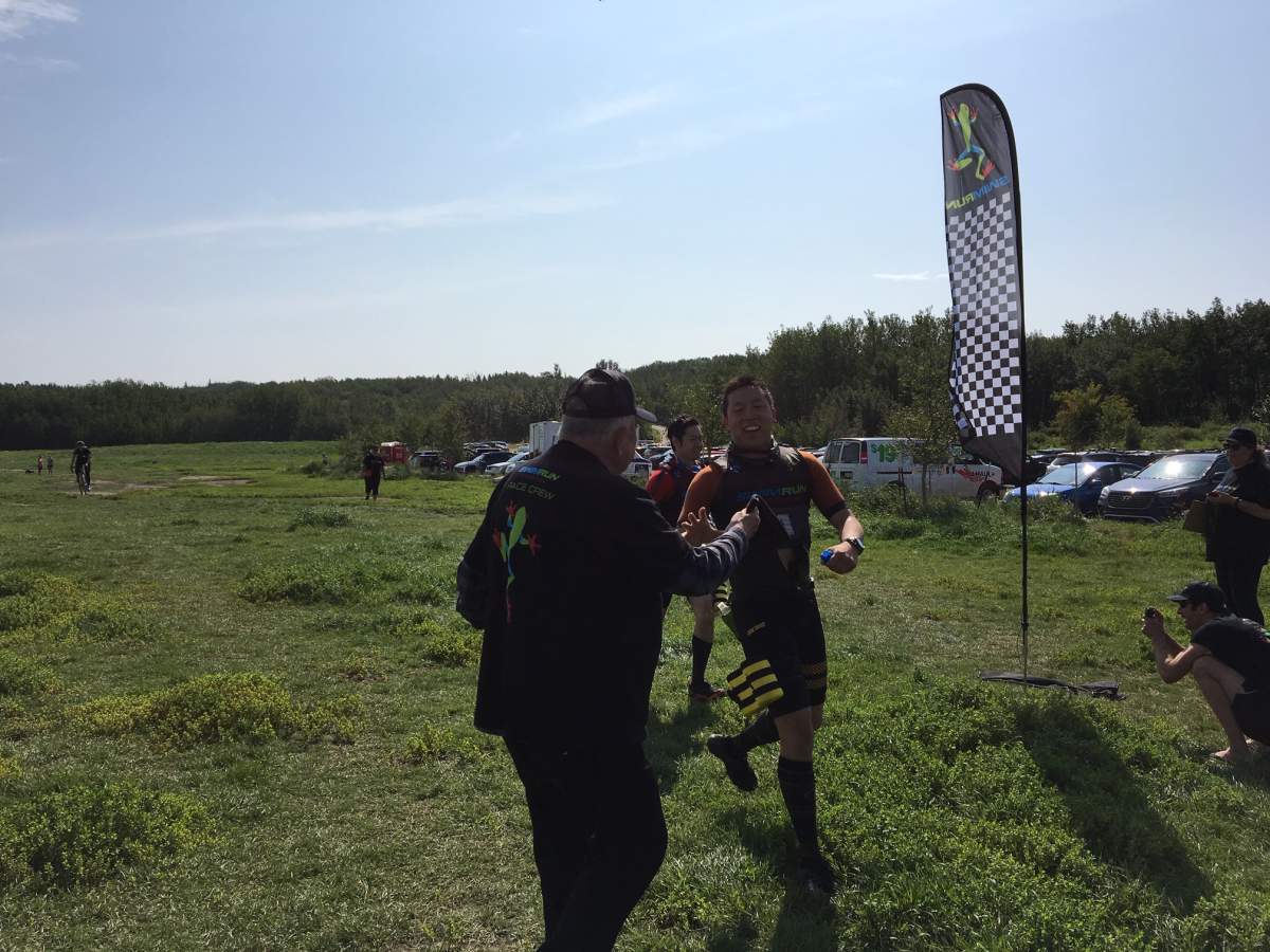 Phil Wong and his partner cross the finish line at Edmonton’s inaugural SwimRun event.