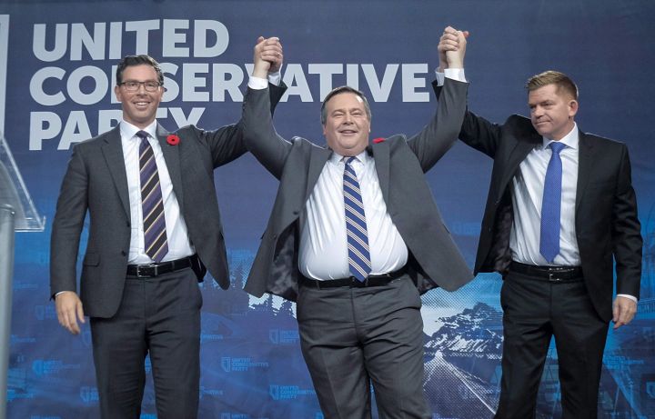 Brian Jean Jason Kenney, centre, celebrates his victory as the first official leader of the Alberta United Conservative Party with his opponents Brian Jean, right, and Doug Schweitzer in Calgary, Alta., Saturday, Oct. 28, 2017.