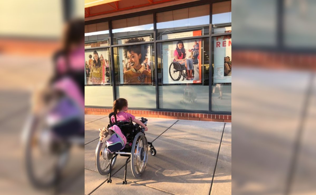 Maren Anderson, 4, looks at an Ulta Beauty advertisement featuring a model in a wheelchair.