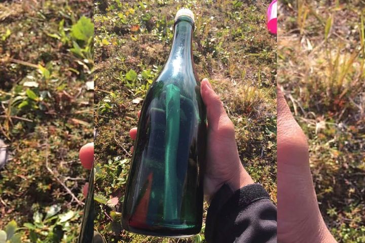 This undated photo provided by Tyler Ivanoff shows a bottle with a message that he found on the shores of western Alaska. Ivanoff found the handwritten Russian letter dated 1969 early this month while gathering firewood near Shishmaref about 966 kilometers northwest of Anchorage, KNOM-AM reported Tuesday, Aug. 13. 