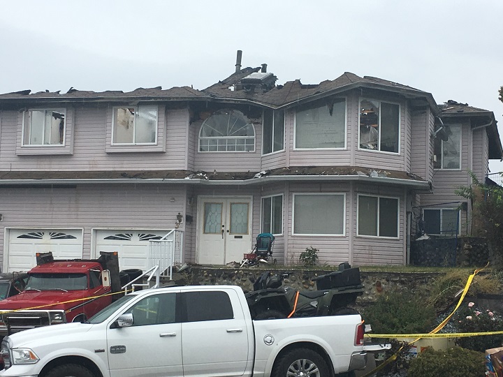 A closer view of the fire-damaged home.