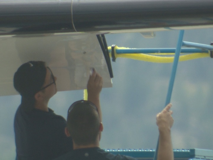 Repair crews working on the WestJet Q400 aircraft.