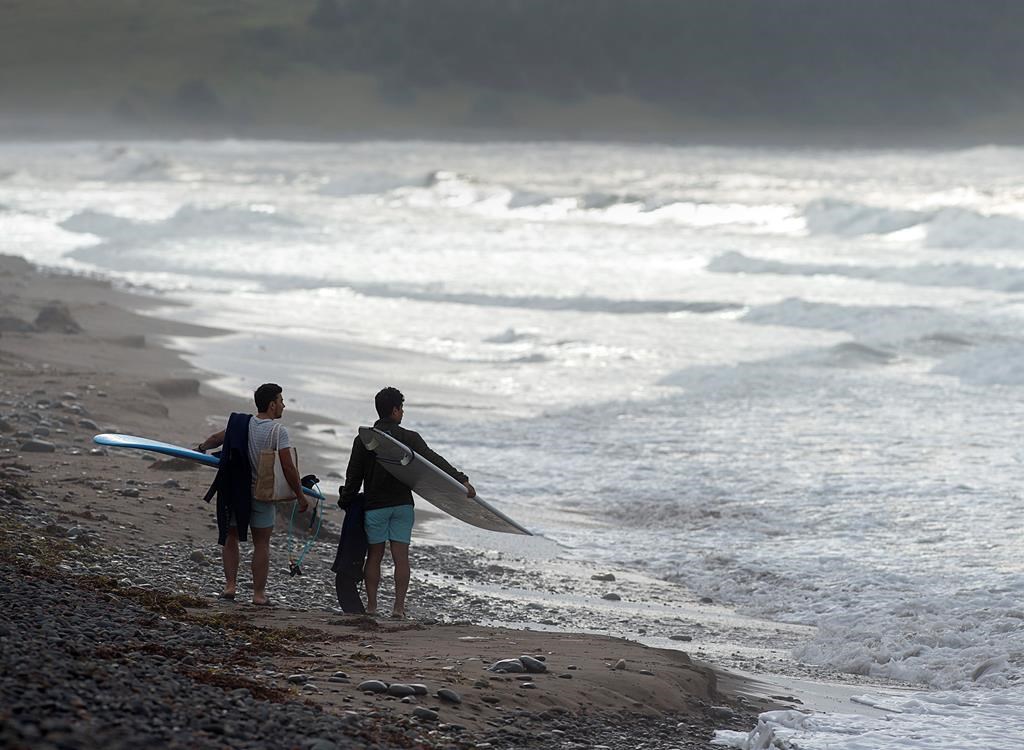 Surfers check the waves in the aftermath of post-tropical storm Erin at Lawrencetown Beach, N.S. on Friday, Aug. 30, 2019.
