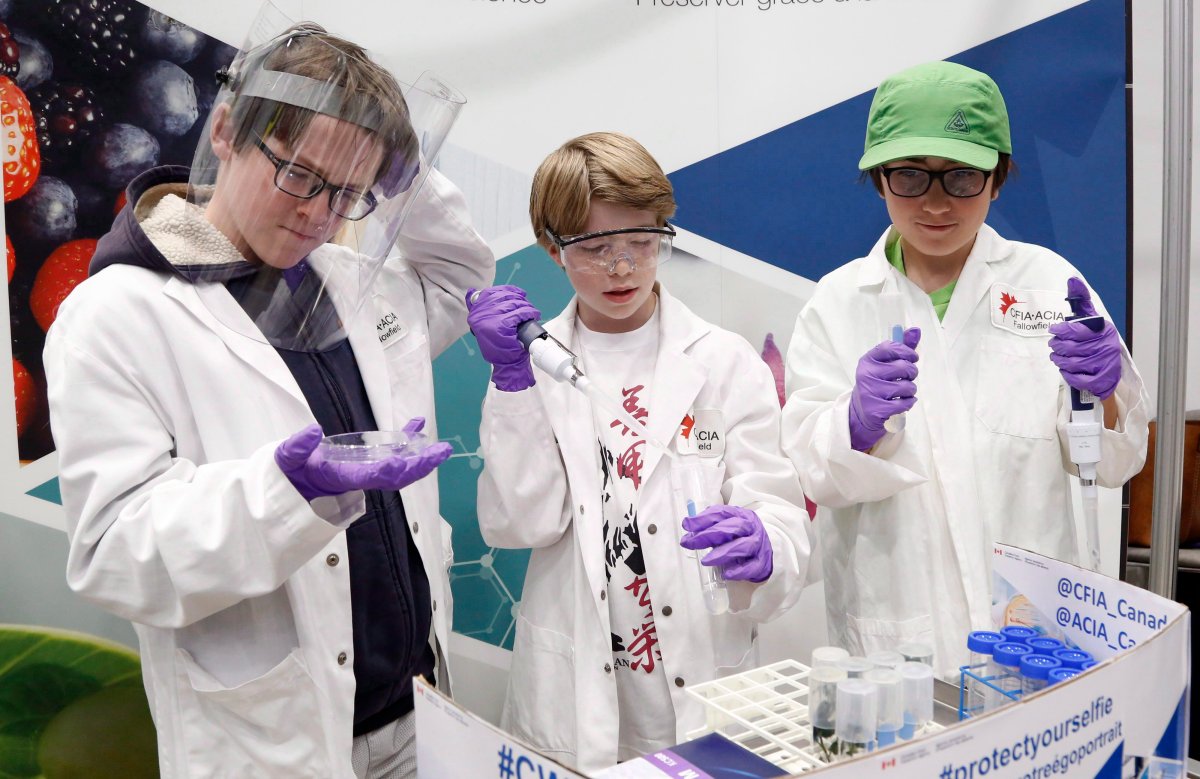 Young scientists of First Avenue Public School in Ottawa check out a Canadian Food Inspection Agency exhibit at the Canada-Wide Science Fair at Carleton University in Ottawa on Wednesday, May 16, 2018. 