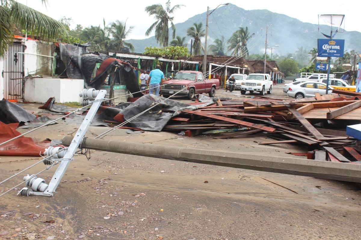 Residents are seen near debris from a restaurant damaged by rain storm caused by Tropical Storm Lorena is pictured at a beach in Manzanillo, in Colima state, Mexico September 19, 2019.
